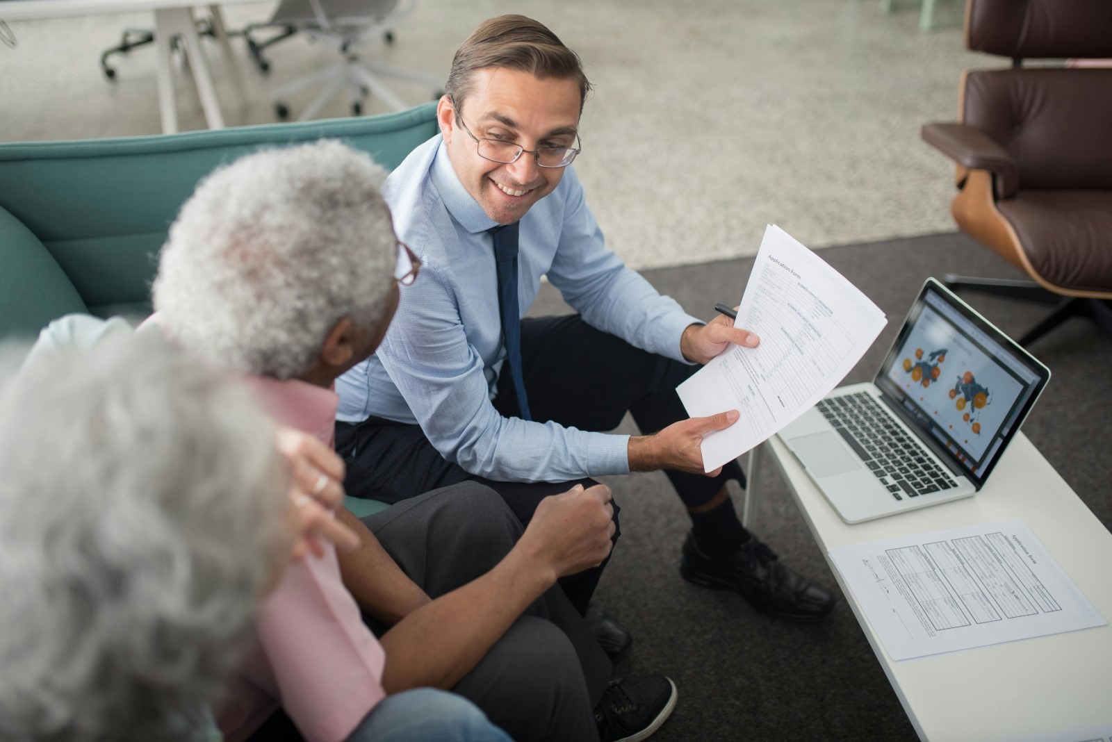 insurance agent explaining insurance policy to elders 